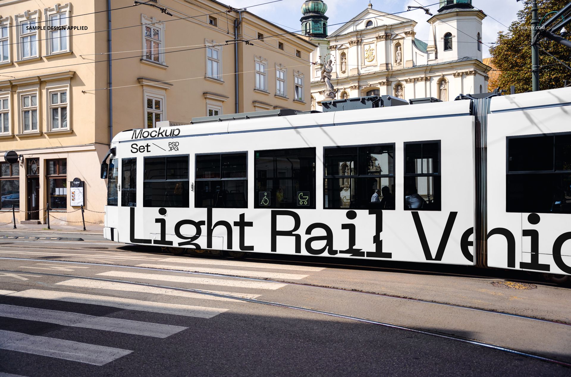 Side perspective of a city light rail vehicle mockup with bold black lettering, set against urban architecture and crosswalk.