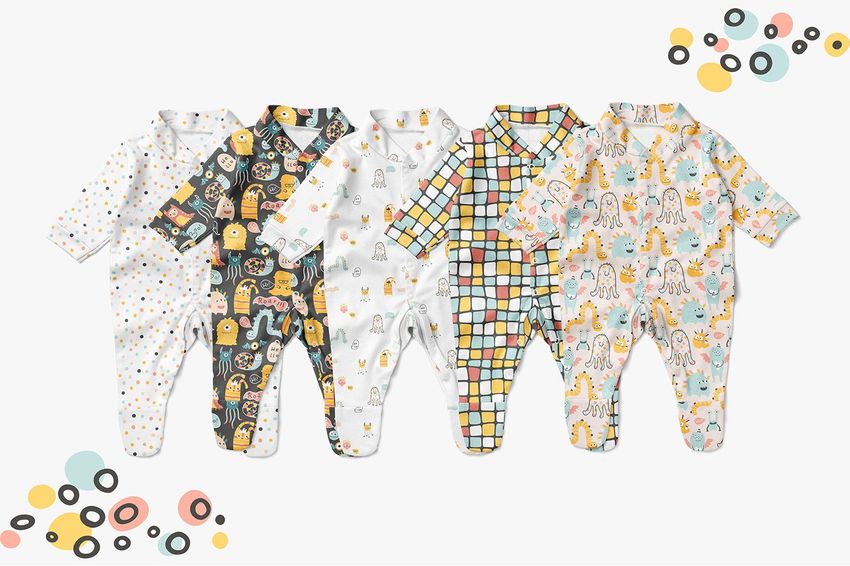 Babygrow mockup showing five long-sleeve sleepsuits with varied patterns, including monsters and dots, on a white surface.