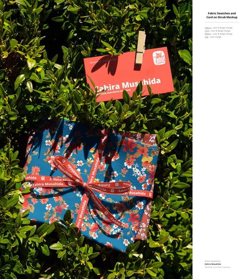 PSD mockup showing colorful fabric swatches and a red card clipped to a branch in a sunlit outdoor setting.