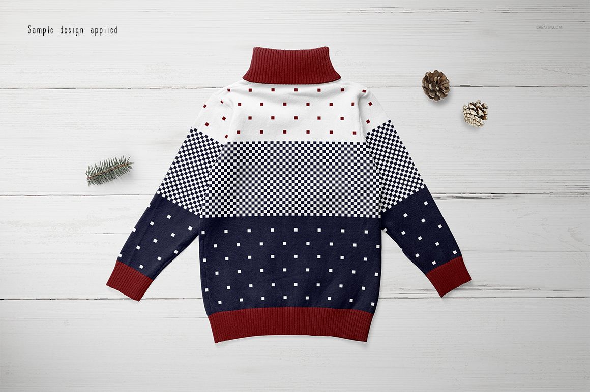 Kids turtleneck sweater mockup displayed flat on a white wooden surface, featuring geometric and dotted patterns.