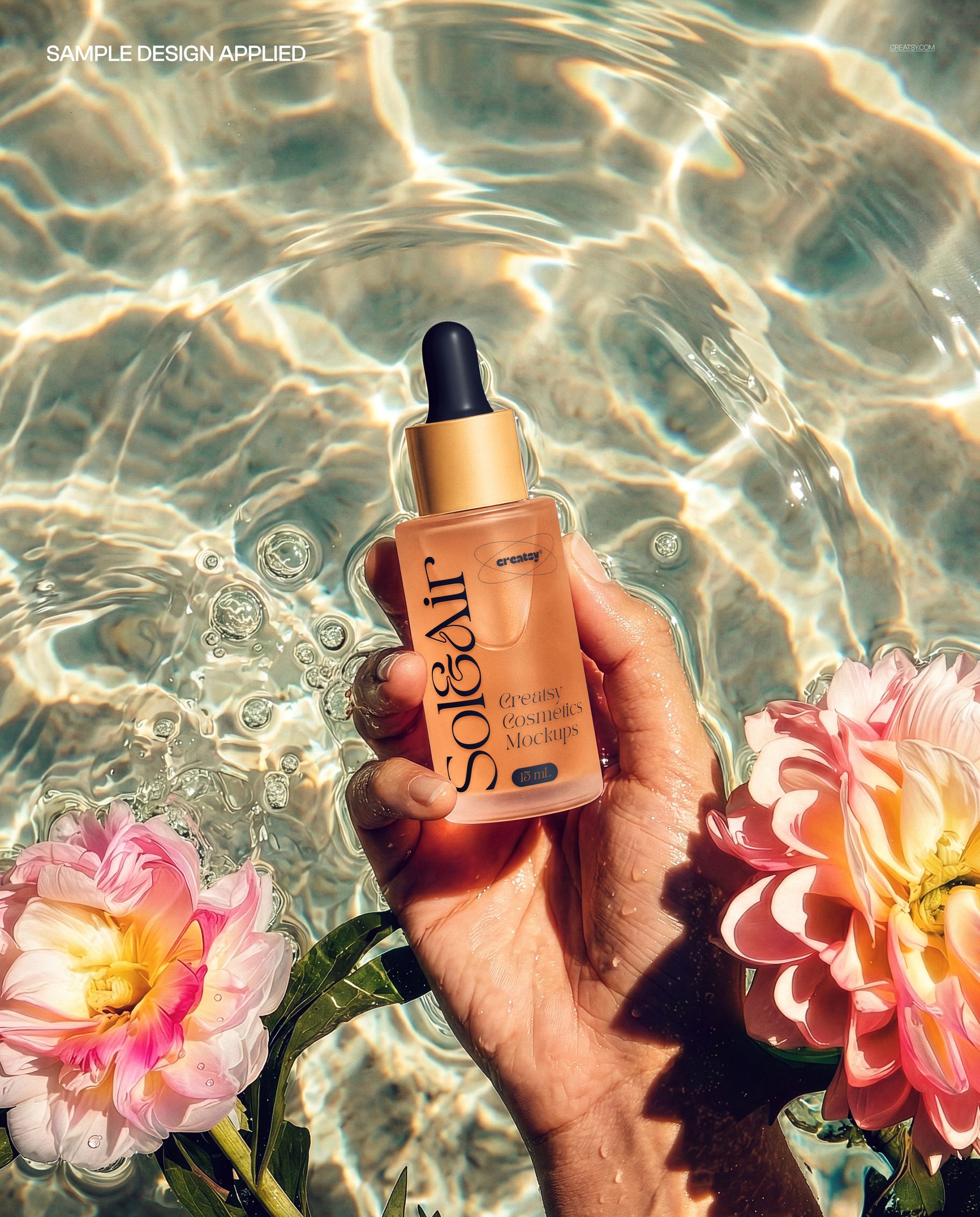 Hand holding a dropper bottle above clear water with ripples and floral accents, close-up mockup scene.