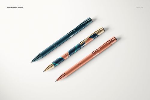 Paragon Pen PSD mockup showing three metallic pens in different colors, viewed from above on a clean white surface.