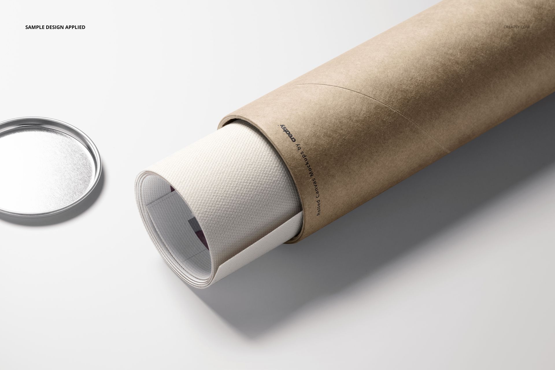 Rolled canvas print mockup showing textured white canvas emerging from a brown tube, lid placed nearby on a pale background.