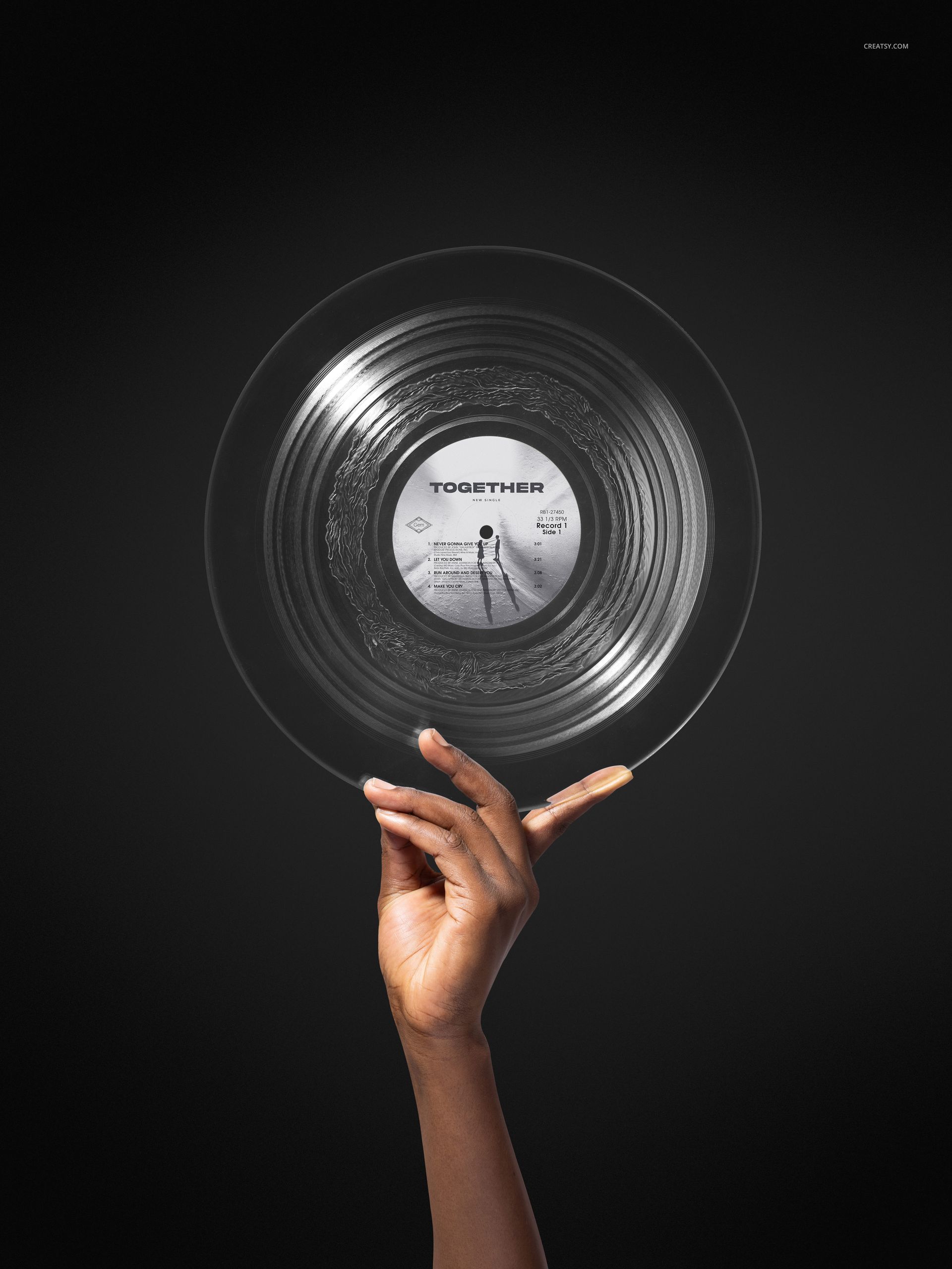 Hand holding a clear vinyl record with a visible center label against a dark background, music mockup scene.
