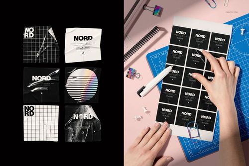 Square stickers with black and white geometric designs displayed in a grid and being peeled on a pink workspace.