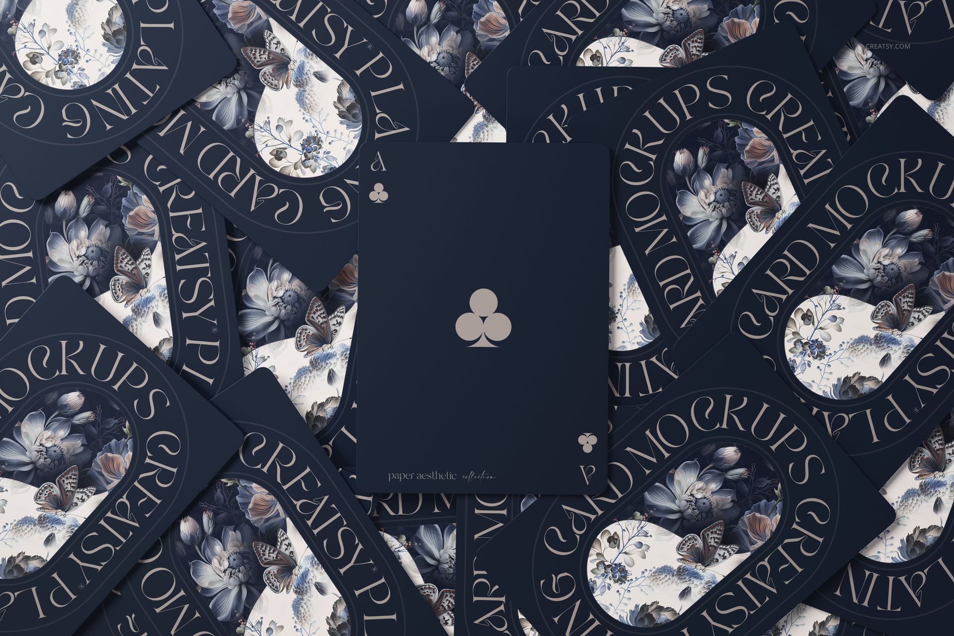 Top view of playing cards mockup with dark blue backs, floral patterns, and a centered club symbol design.