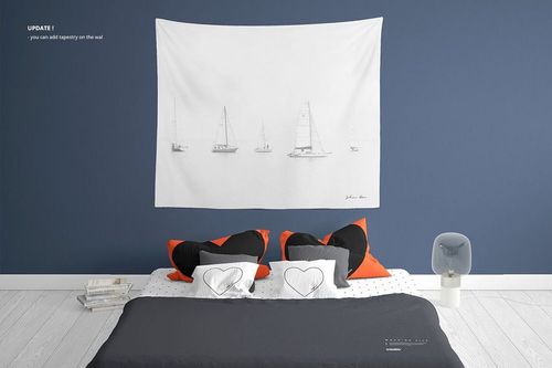 Bedroom mockup with a bed dressed in gray and white linens, orange and heart-shaped pillows, and a nautical wall tapestry.
