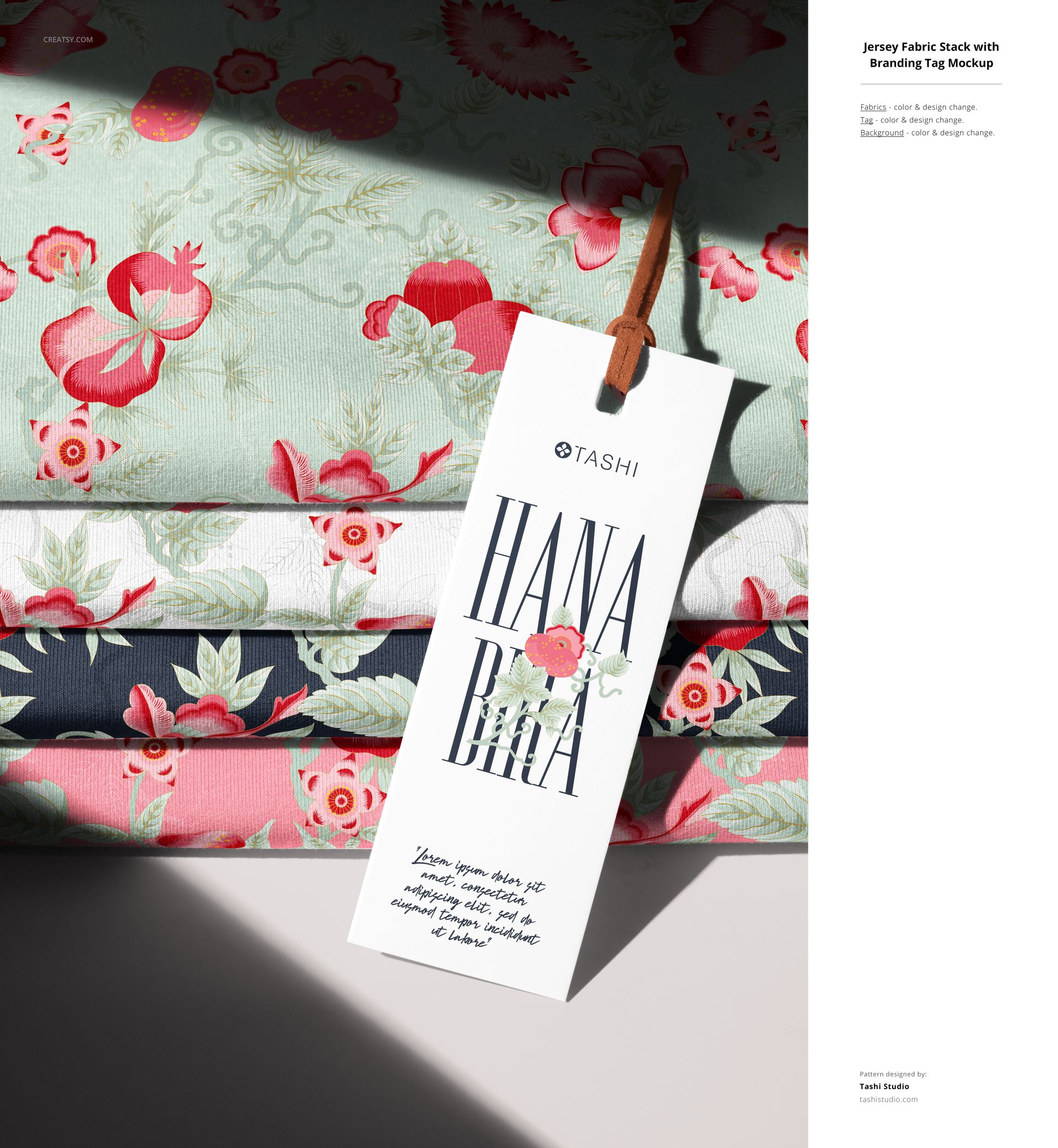 PSD mockup featuring folded jersey textiles with intricate floral designs and a hanging label, arranged in a neat stack.