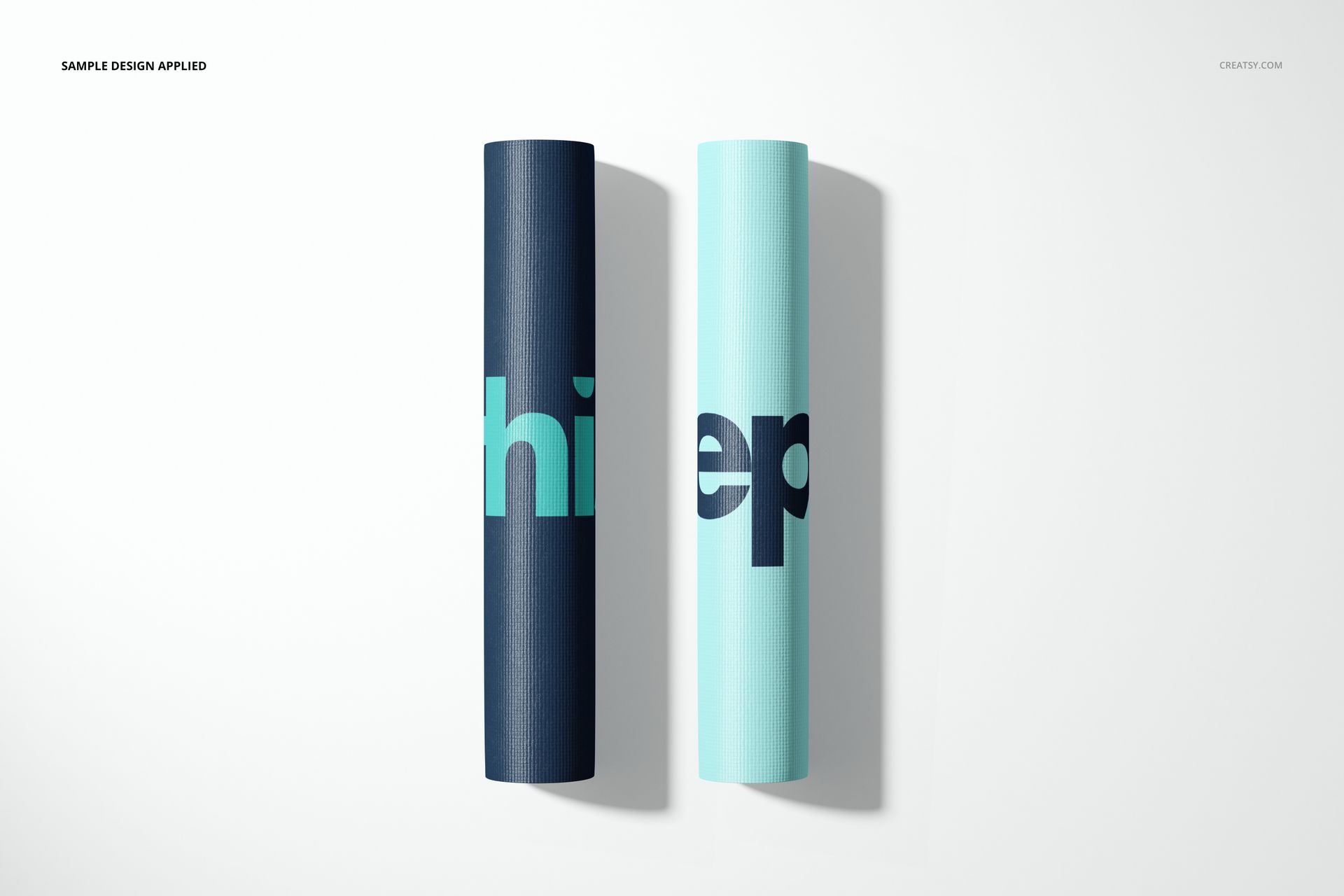Rolled exercise mat mockup set with contrasting blue colors and large letter patterns, displayed on a plain surface.