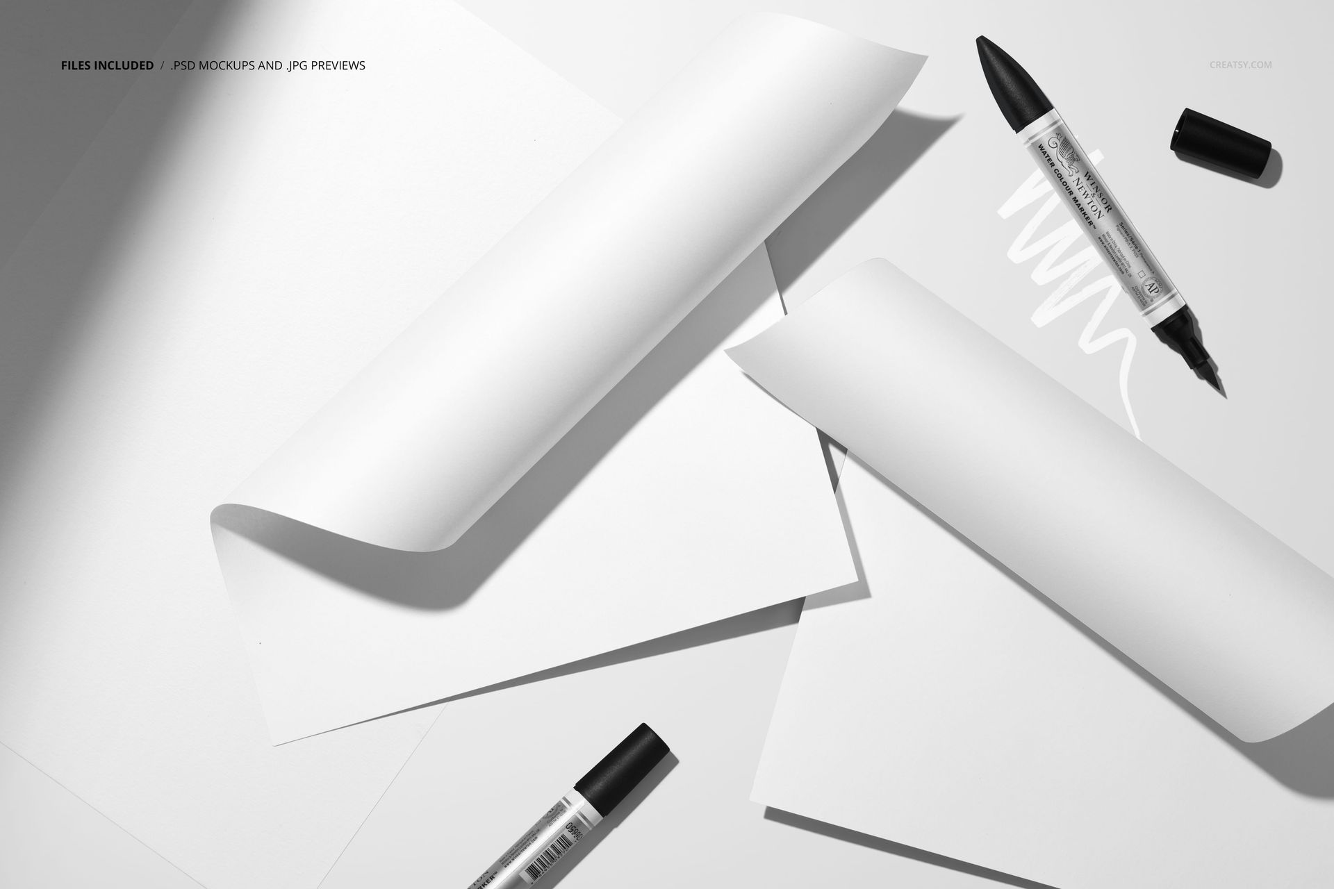 Top view of two folded white paper sheets and three black markers on a light surface with shadows, mockup scene.