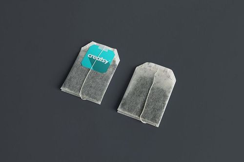 Tea bag PSD mockup set with two bags side by side, highlighting a changeable label and neutral backdrop.