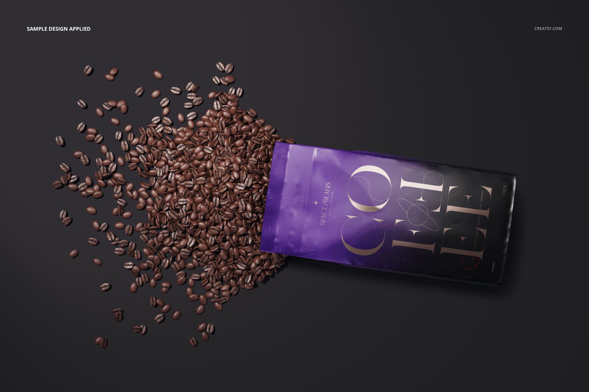 Glossy coffee bag mockup lying on a dark surface with coffee beans spilling out, viewed from above.
