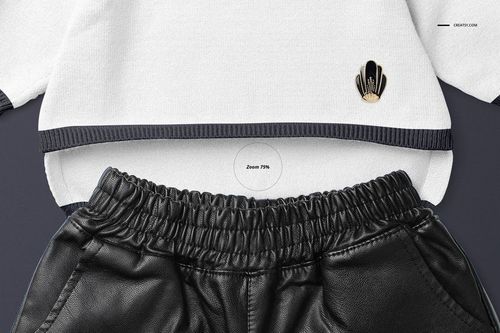 Front view of a baby sweater mockup in white with dark trim, paired with black faux leather pants on a plain background.