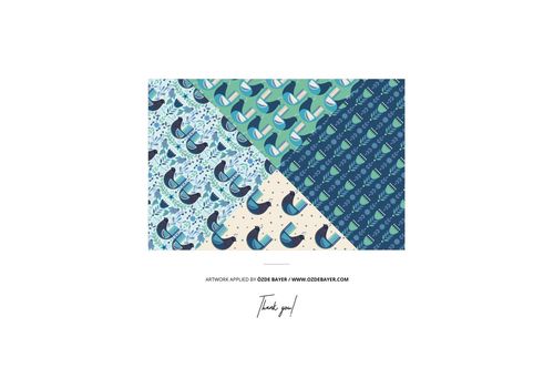 Mockup showing three different blue and green gift wrapping paper designs displayed from a top-down perspective.