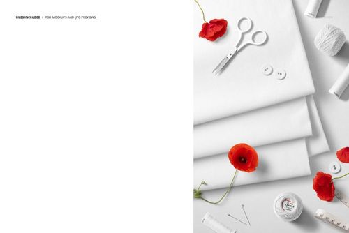 PSD mockup featuring layered white jersey fabrics, sewing accessories, and bright red flowers arranged on a white background.
