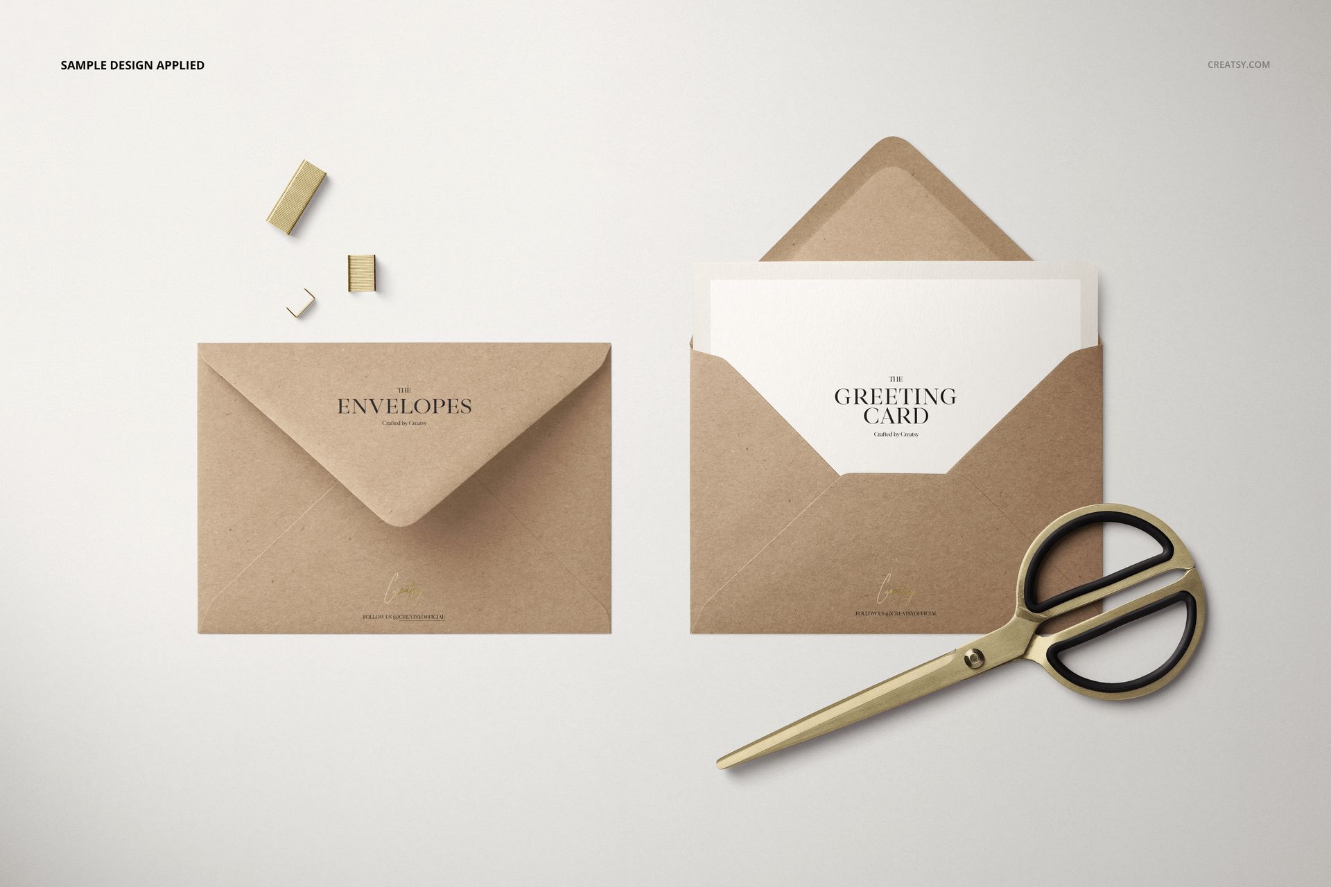Kraft paper C6 envelopes displayed on a light surface, one open with a greeting card inside, gold scissors nearby.