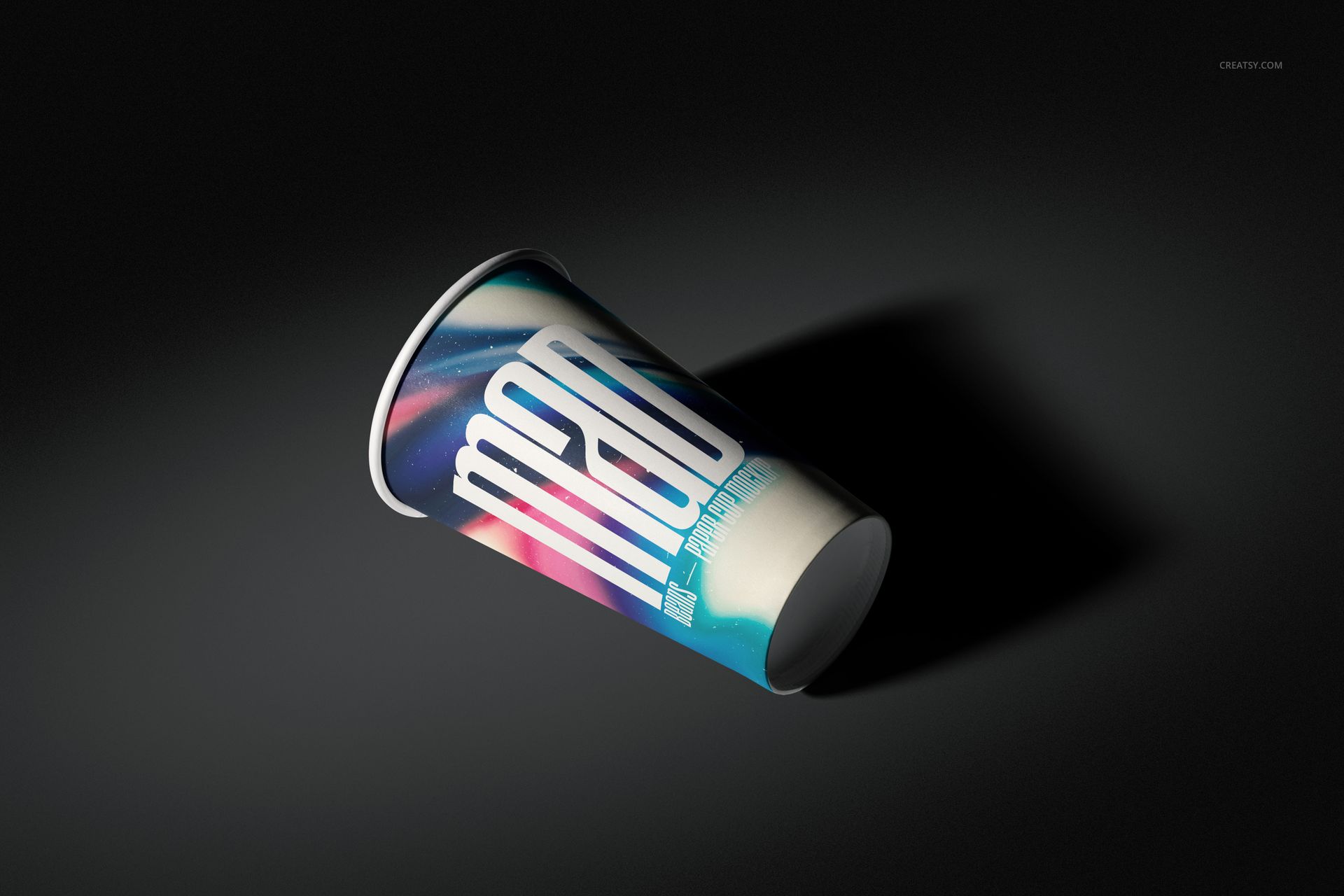 Single paper cup mockup featuring a vibrant gradient pattern and large white lettering, angled on a black surface.
