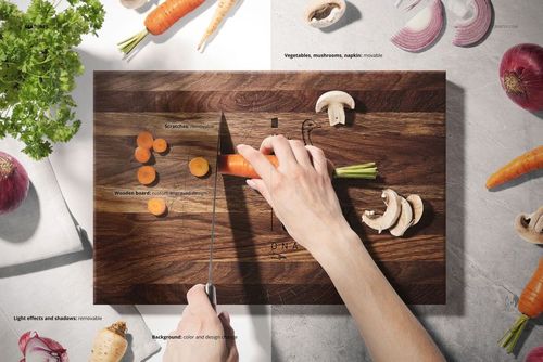 Top view of a rectangular end grain wood cutting board mockup with sliced carrots, mushrooms, onions, and parsley on a light surface.