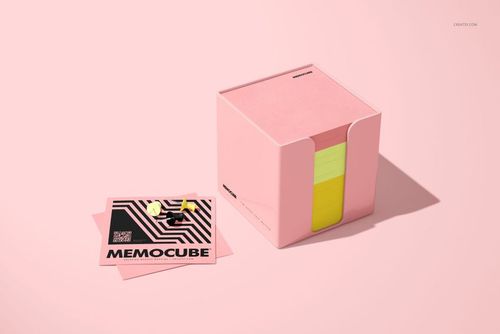 Stationery mockup showing a cube-shaped memo block in an acrylic holder, with pink and yellow notes and a graphic card nearby.