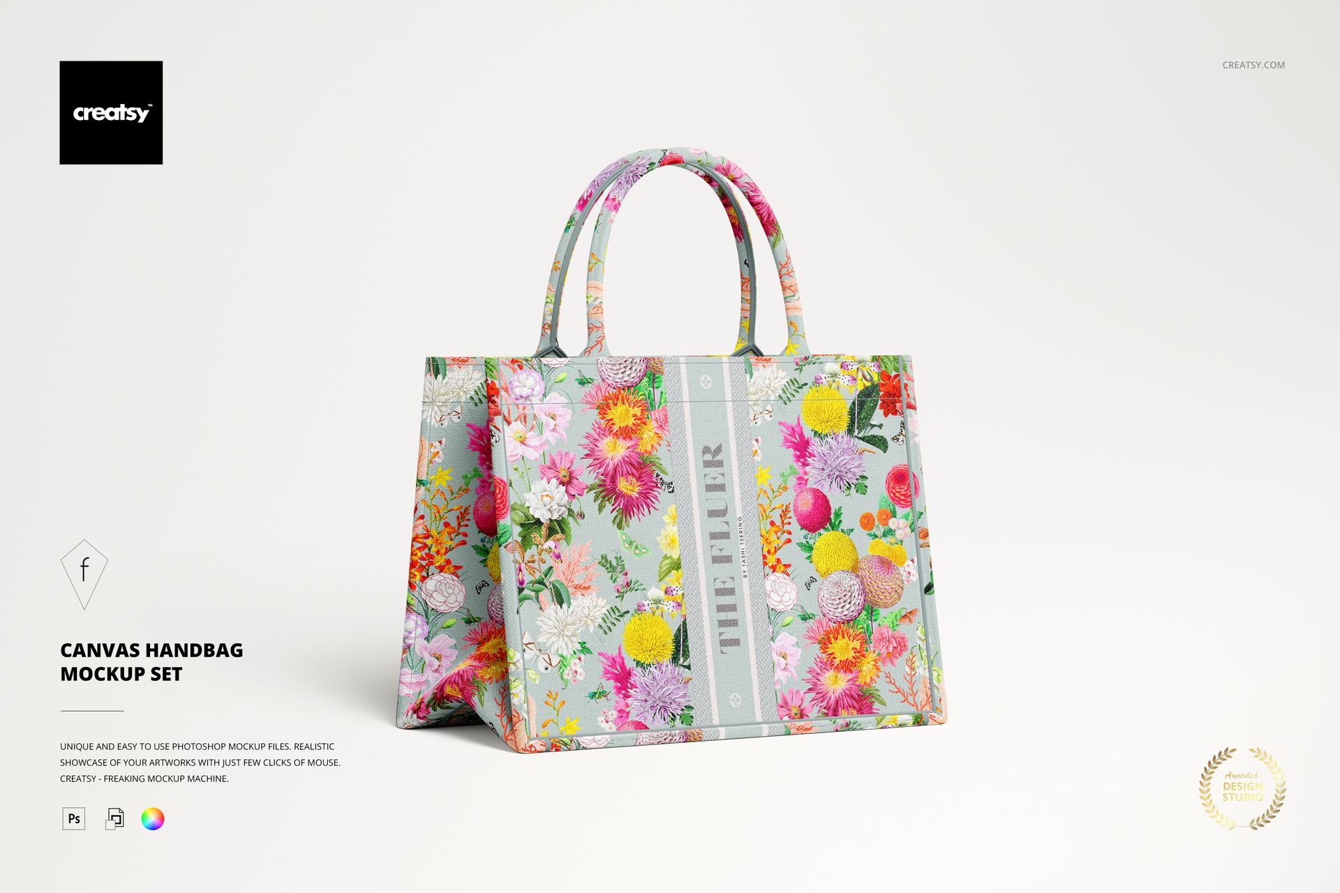 PSD mockup showing a canvas handbag with bright flower designs, detailed stitching, and shadow on a light background.