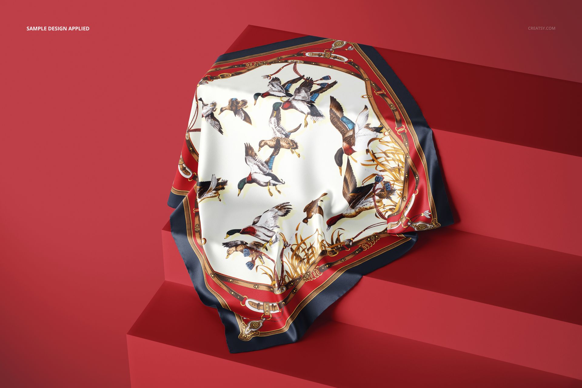 Elegant silk fabric mockup displayed on red steps, showing a bird-themed design with gold and red accents.