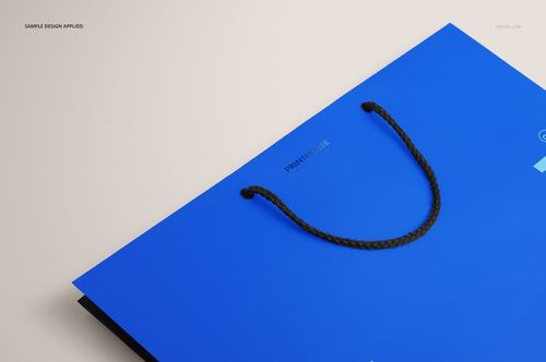 Eurotote bag mockup featuring a vibrant blue color, black rope handles, shown from a top angled perspective on a neutral surface.