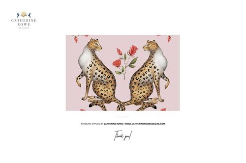 Front view of a fringed velvet cushion mockup featuring two illustrated leopards and red roses on a pale pink background.