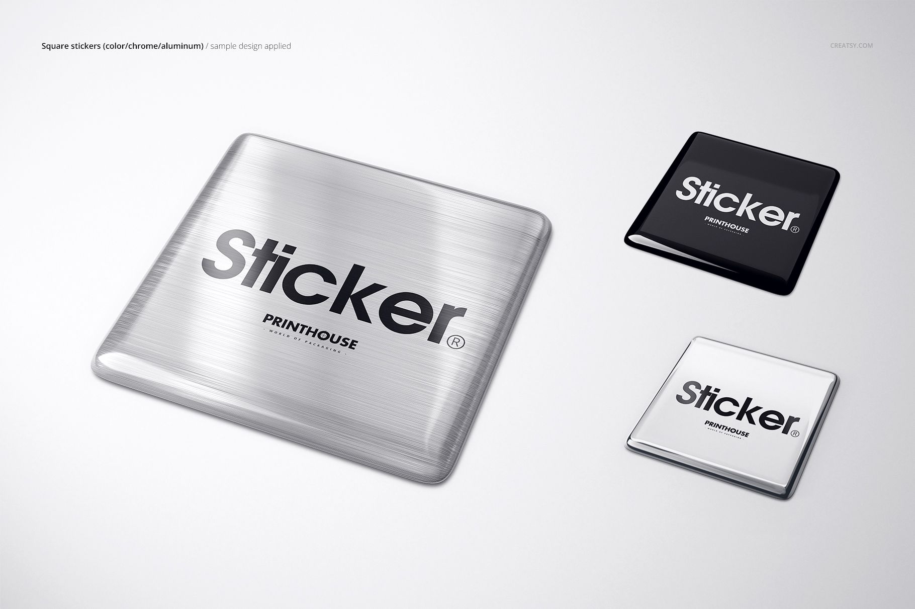 Mockup of three metallic square stickers with epoxy dome finish in silver, black, and white, top view.