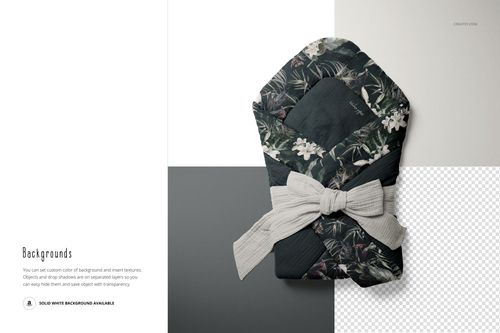 Top view of a muslin baby wrap mockup featuring a leafy floral design and a textured gray bow on mixed backgrounds.