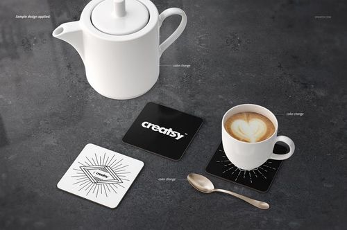 PSD mockup of rectangular coasters featuring monochrome designs, styled with a white teapot, cup, and spoon on a gray surface.