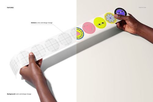 Hands holding a long strip of round stickers with colorful designs on a light studio background, PSD mockup scene.