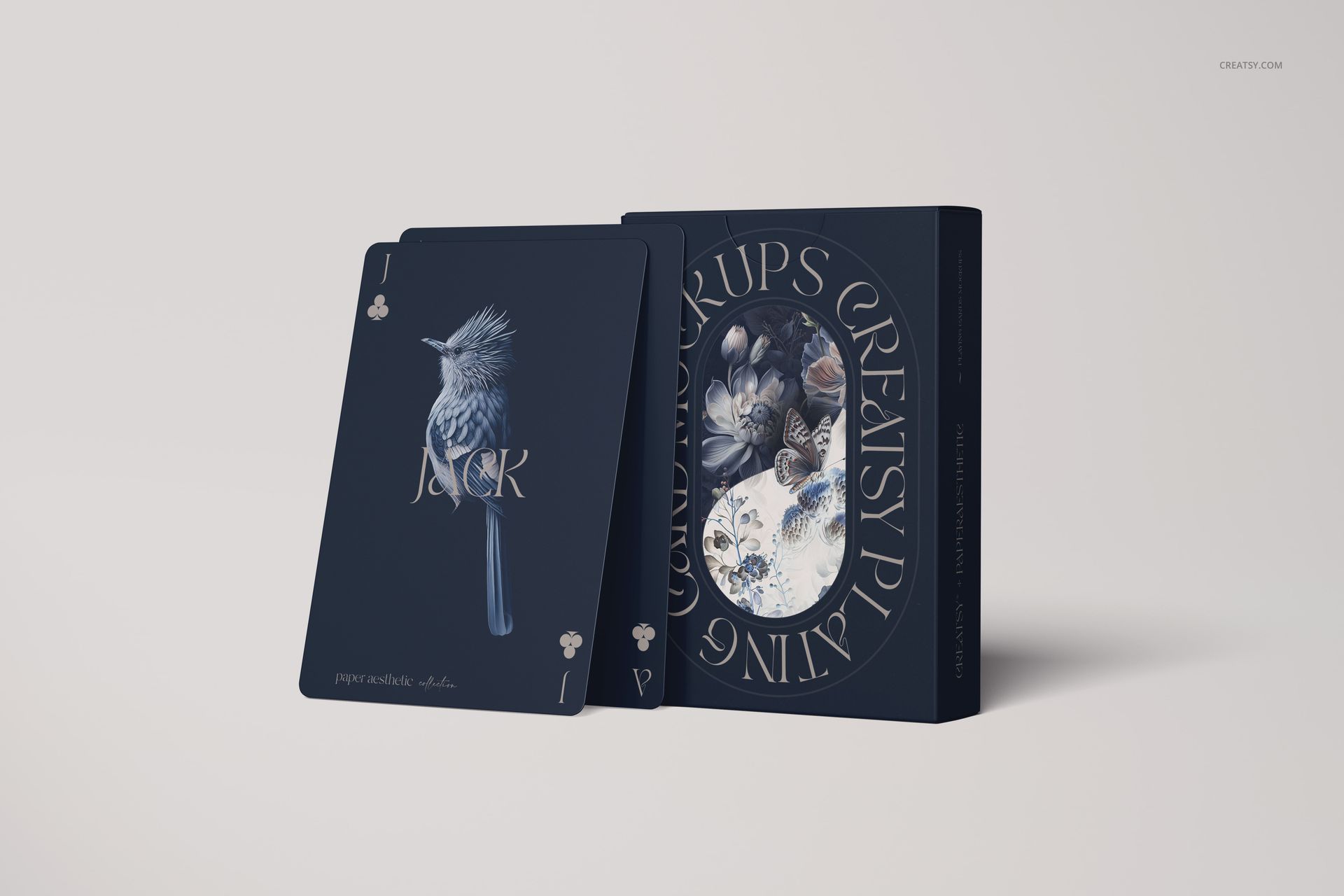 PSD mockup showing stylish playing cards with a bird design and a coordinating box, displayed against a plain backdrop.