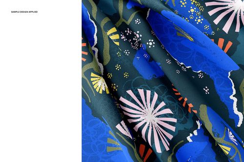 Detailed view of silk textile mockup featuring vibrant blue and pink floral shapes on a dark background with visible creases.
