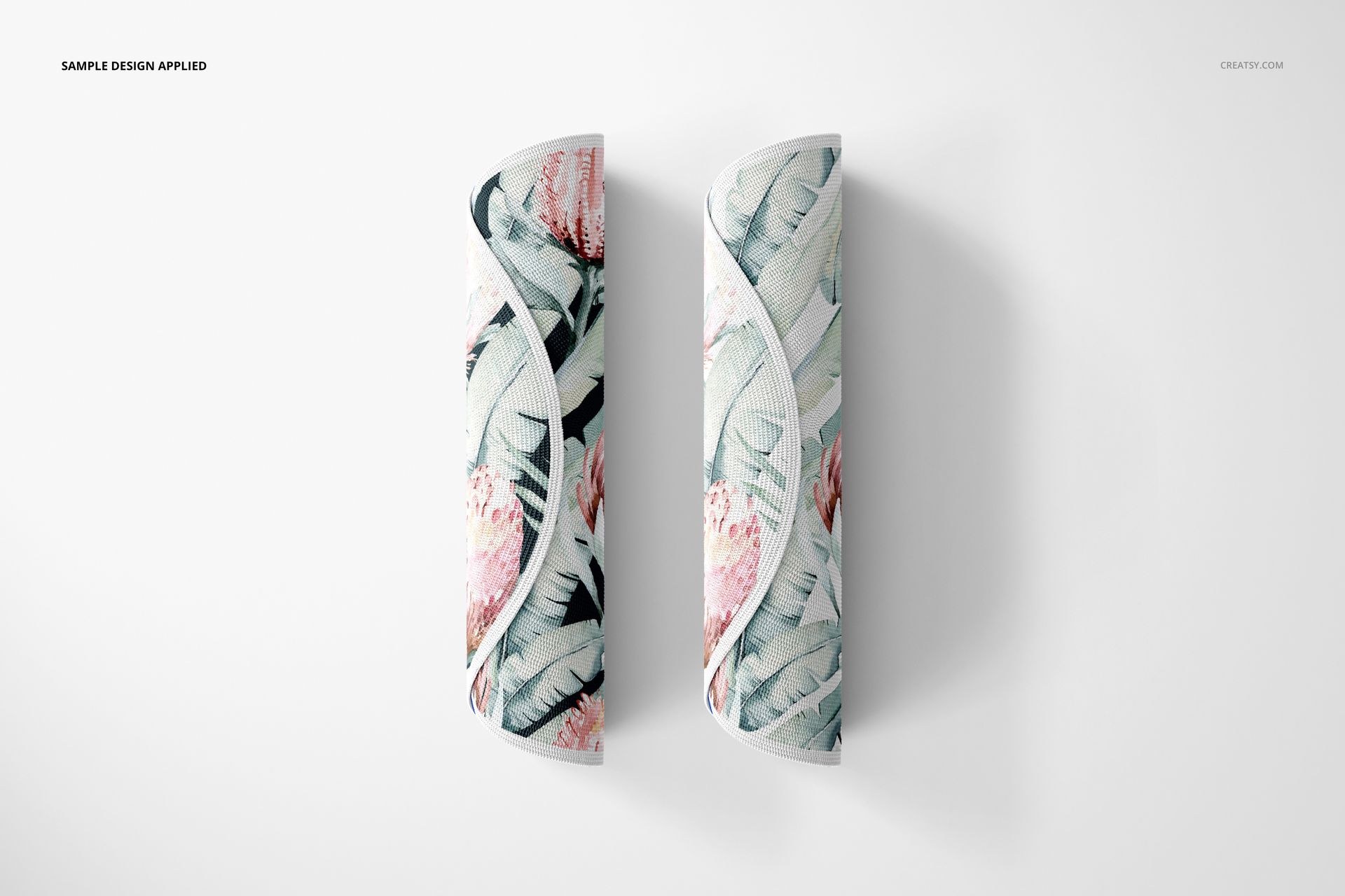 Two knitted round rug mockups featuring pastel botanical designs, shown rolled up against a plain white surface.