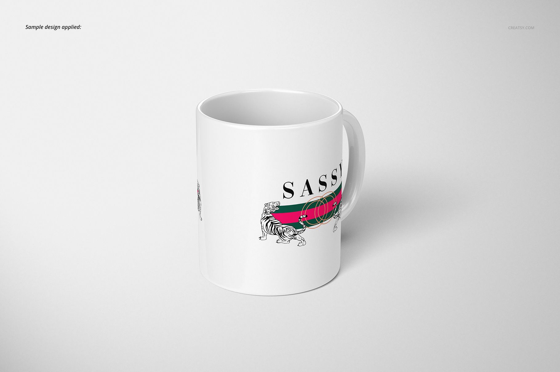 White ceramic mug with a printed design featuring a tiger, colored stripes, and bold text, shown at an angle on a light background.