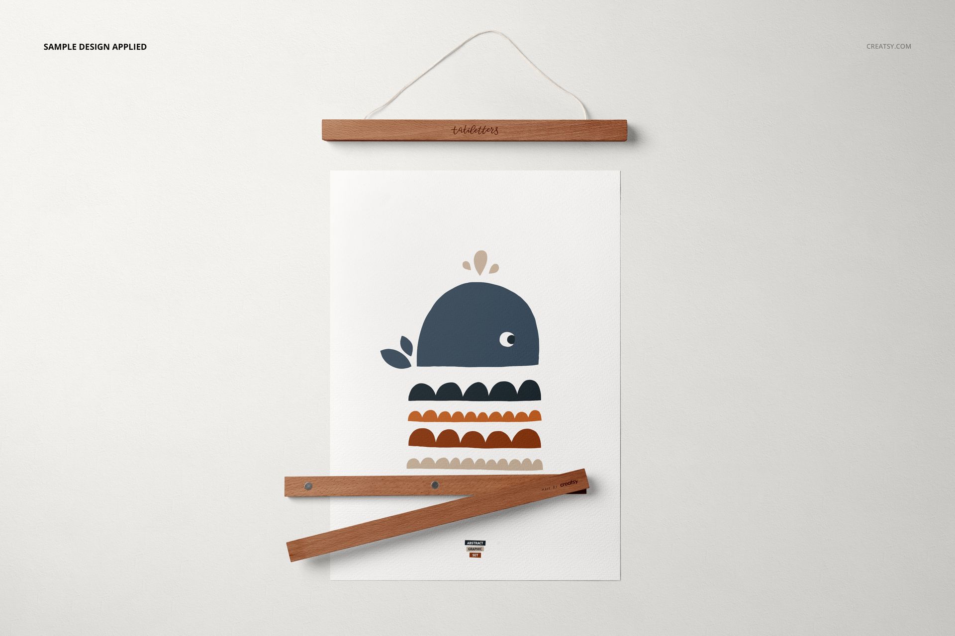 A3 poster mockup featuring a simple whale graphic, displayed with top and bottom wooden hangers on a white surface.