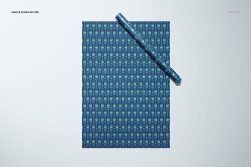 Gift wrapping paper mockup displayed flat with a roll, showing a blue and green repeating pattern, viewed from above.