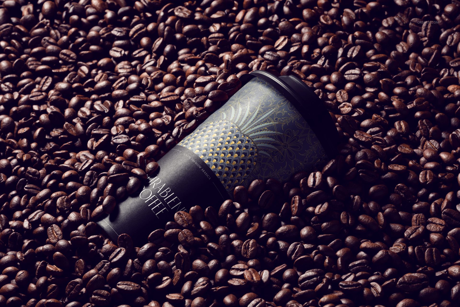 PSD mockup of a black coffee cup featuring intricate gold design, surrounded by whole coffee beans, close-up angle.
