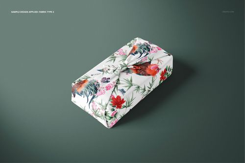 Furoshiki fabric wrap mockup featuring a colorful rooster and floral design, shown from a slightly elevated front view.