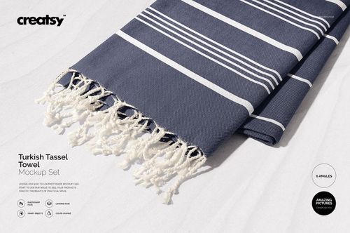 Turkish tassel towel mockup featuring horizontal navy and white stripes, tassels visible, photographed in daylight.