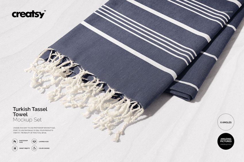 Turkish tassel towel mockup featuring horizontal navy and white stripes, tassels visible, photographed in daylight.