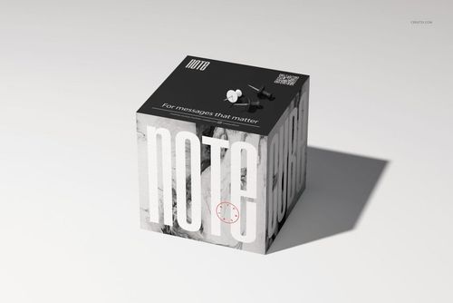 Mockup of a square note cube with large white lettering, black top surface, and subtle shadow on a light background.