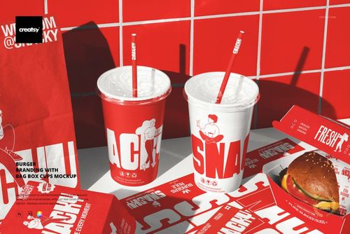 Front view of burger packaging mockup featuring red and white branded paper bags, cups, boxes, and a burger on a tiled surface.