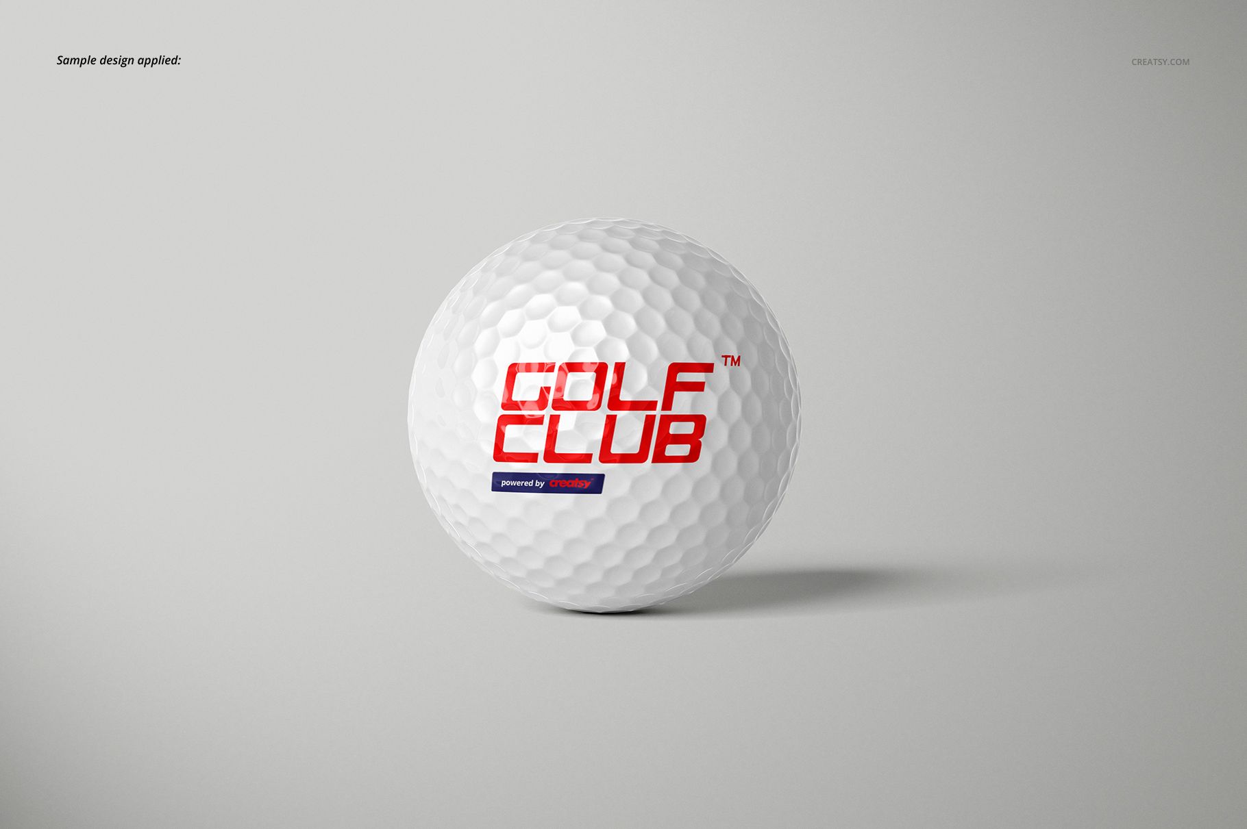 White golf ball with a red and blue logo, displayed on a light gray background in a front-facing mockup scene.