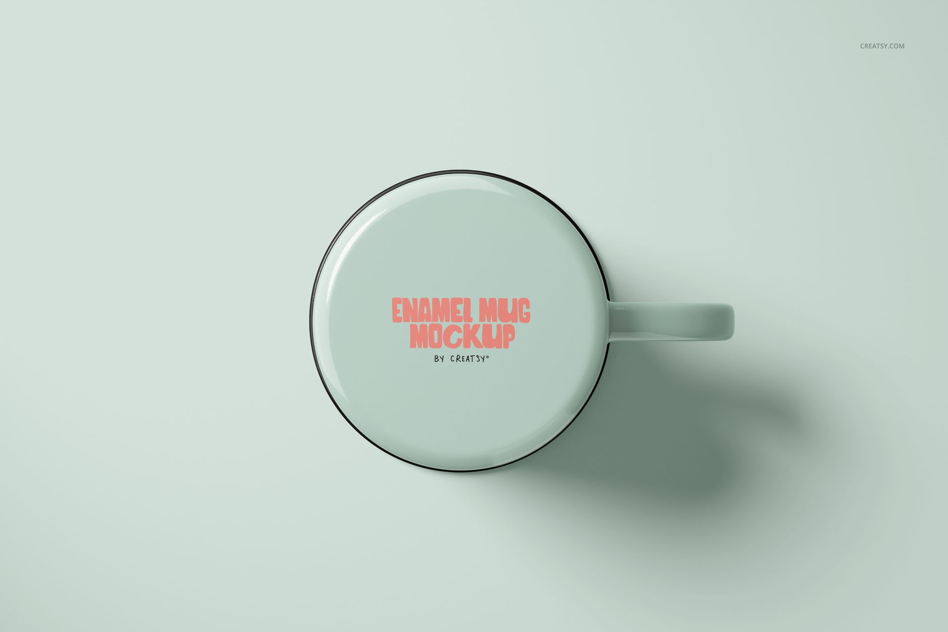 White enamel mug mockup shown from above, displaying pink lettering on the side, set on a pale surface.