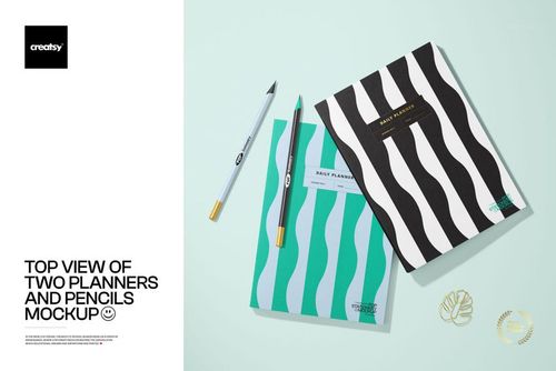 Stationery mockup showing two planners with bold wavy patterns and two pencils arranged on a light blue surface.