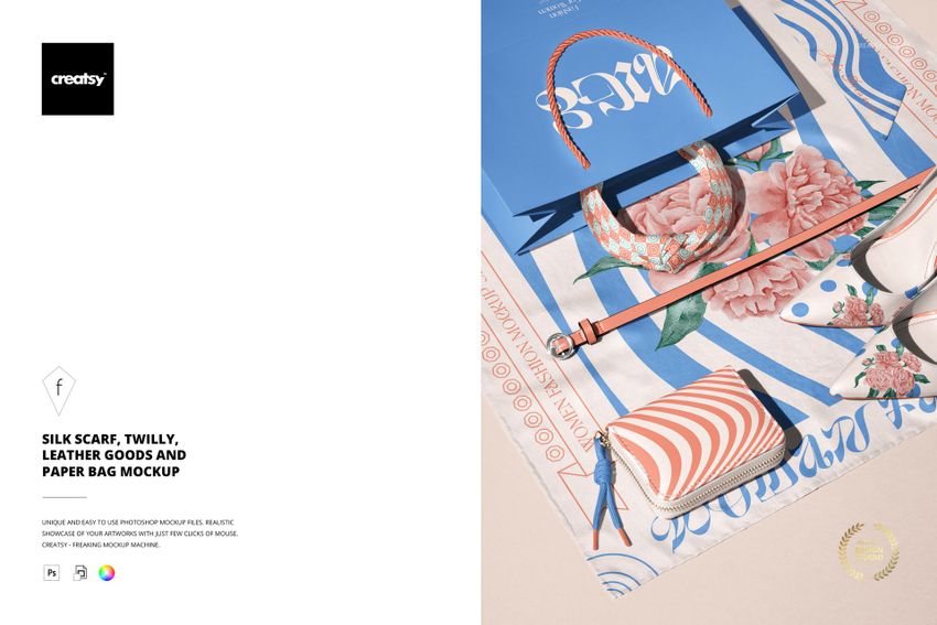 Flat lay of a silk scarf with geometric design, twilly, striped leather wallet, and blue paper bag mockup.