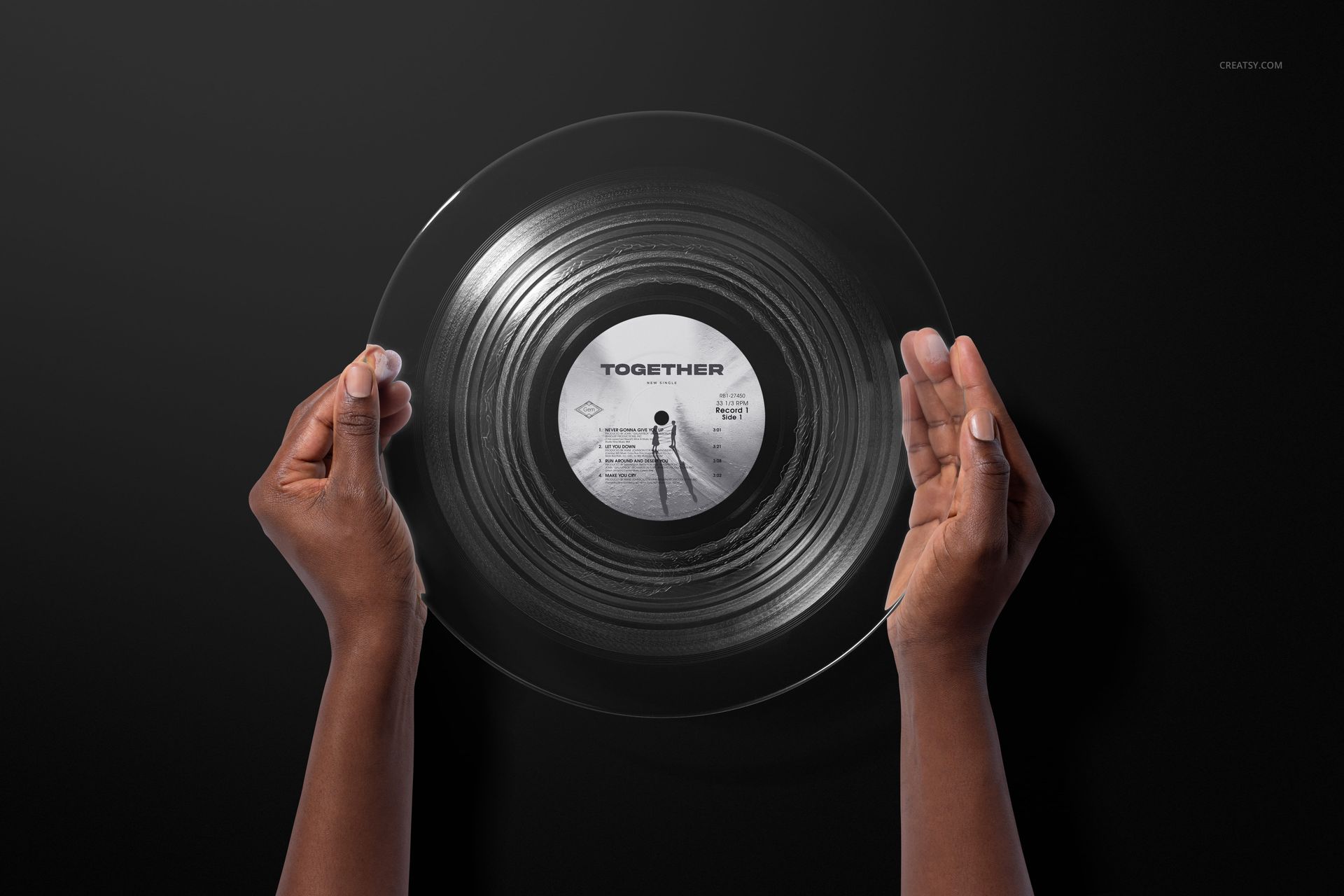 Clear vinyl record mockup with visible grooves and label, held by hands in front of a plain dark surface.