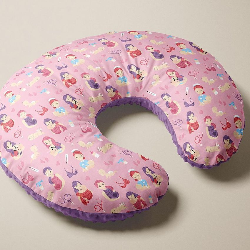 Boppy nursing pillow mockup with a pink cover featuring a playful mom and baby pattern, shown on a neutral background.