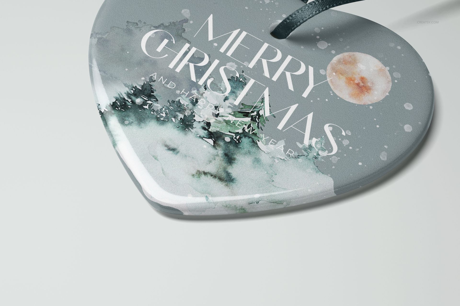 Heart-shaped ceramic Christmas ornament mockup with watercolor tree design, front view on light background.